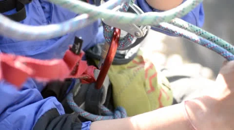 Belaying ropes through belay device Stock Footage 23765196