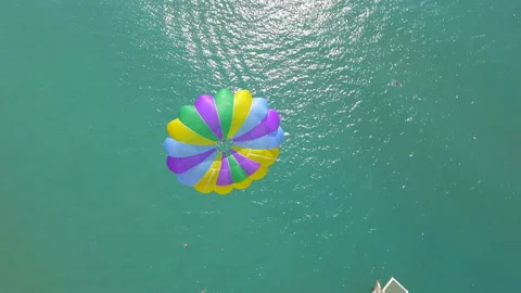 Belek, Turkey - September 27, 2023: Happy couple flying on a parachute Stock Footage 252136280