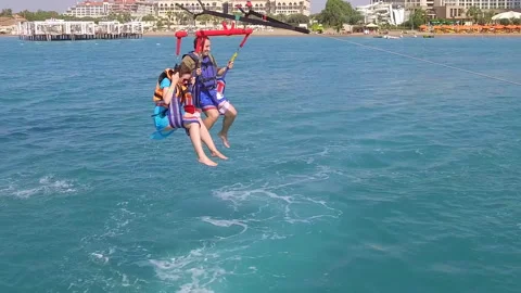 Belek, Turkey - September 27, 2023: Happy couple flying on a parachute Stock Footage 252137782