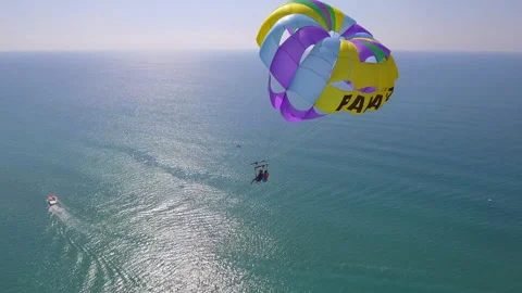 Belek, Turkey - September 27, 2023: Happy couple flying on a parachute Stock Footage 252138570