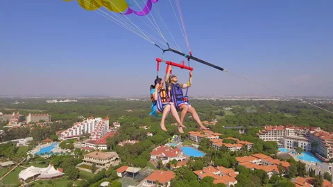 Belek, Turkey - September 27, 2023: Happy couple flying on a parachute Stock Footage 252139614