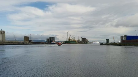 Belfast dock and pilot boat rushing over the harbour with cranes in the Stock Footage 121099239