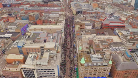 Belfast St. Patrick’s Parade – Drone Crowd &amp; buildings View Stock Footage 314320627