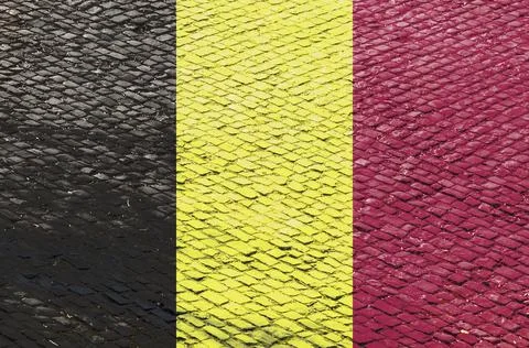 Belgian Flag on a Cobblestone Road Pattern Stock Photos