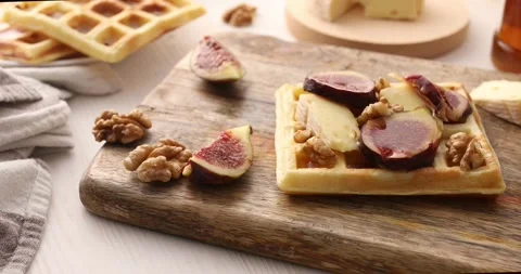 Belgian waffle with brie cheese, figs, walnuts and drizzled with honey. Stock Footage 250177487