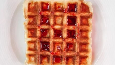 Belgian waffle with cherry jam on plate 動画素材 310798612