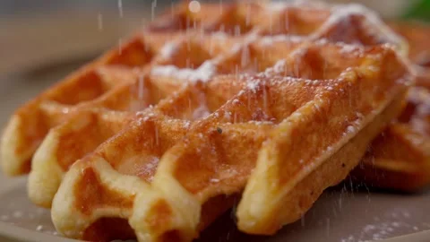 Belgian Waffle Dusted with Powdered Sugar. Perfectly cooked Belgian waffle Stock Footage 270814856