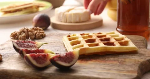 Belgian waffle is topped with brie cheese and figs. Stock Footage 249597718
