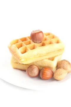 Belgian waffles and nuts on a plate isolated on white Stock Photos