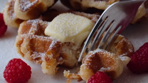 Belgian Waffles and Raspberries with a Fork Closeup Stock Footage 113384329