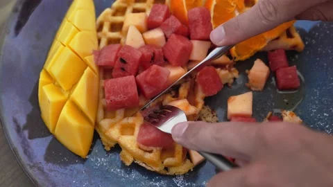 Belgian waffles with Fork take bite pieces of fruit Video stock 171022922