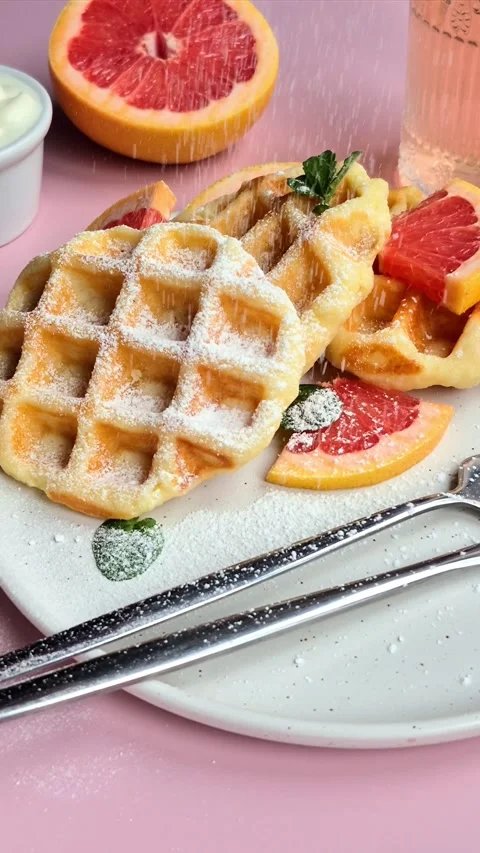 Belgian waffles with grapefruit on a white plate Stock Footage 304873491