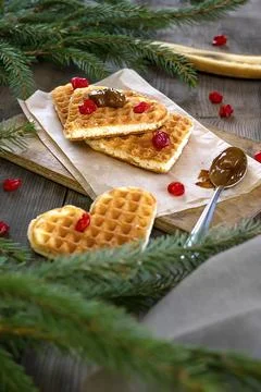 Belgian waffles heart shaped with cherry, and boiled condensed milk.Christm.. Stock-Fotos