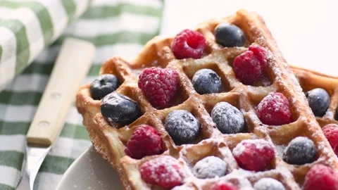 Belgian waffles on plate with berries Stock Footage 134601993