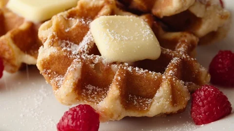 Belgian Waffles with Powdered Sugar and Raspberries Stock Footage 113319693