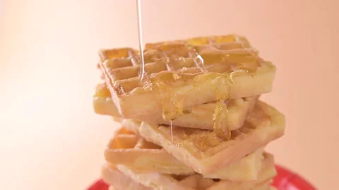 Belgian waffles. Soft fluffy waffles with honey. Traditional breakfast in Stock Footage 207829336