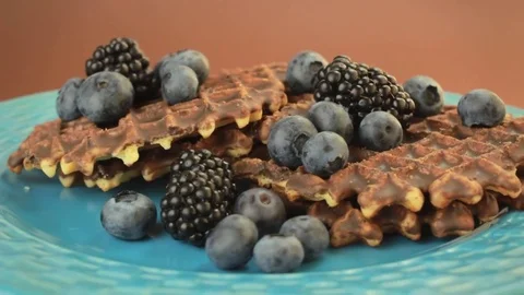 Belgium waffles with blueberries and blackberries rotating Stock Footage