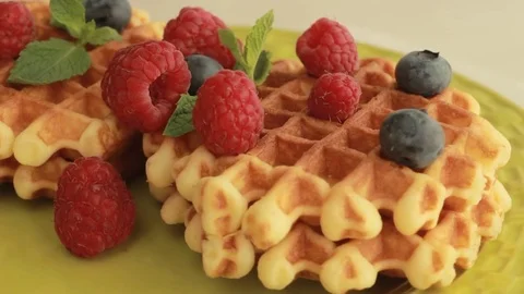 Belgium waffles with blueberries and raspberries rotating Stock Footage