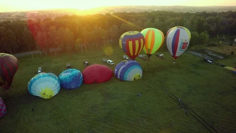 BELGOROD - AUG 4: Balloons fly up in sky with passengers over green field, on Stock Footage 93397077