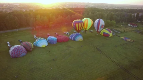 BELGOROD - AUG 4: Balloons fly up in sky with passengers over green field Stock Footage 93397180