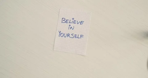 Believe in your self  - a man's hand presents a word on the note Stock Footage 267086993