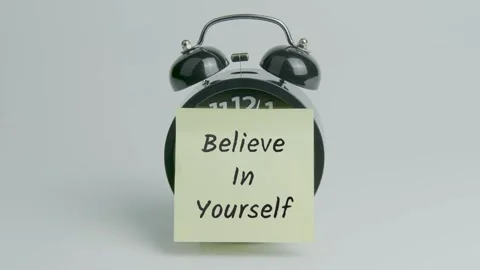 Believe in Yourself Text or Word on Yellow Note Paper Sticking onto Clock Stock Footage 299756495