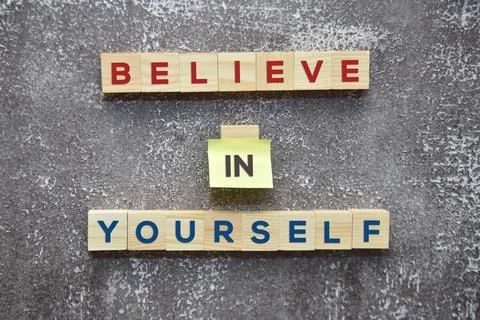 BELIEVE IN YOURSELF word on wooden blocks and sticky note lifestyle concept. Stock Photos