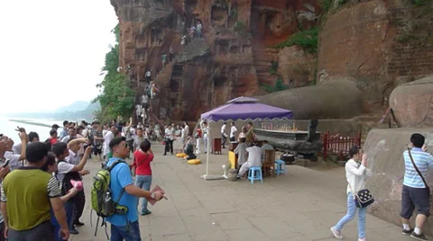Believers climb down the steep and narrow  stair and gather at the Giant Buddha Stock Footage 38657433
