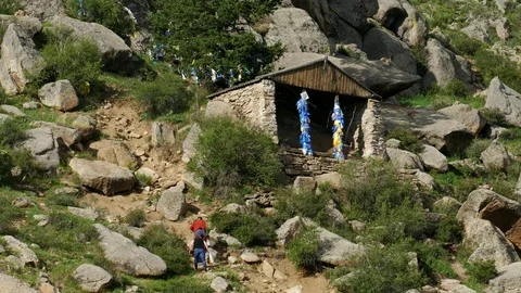 Believers climb the mountain to a small Buddhist chapel. Video stock 89674752
