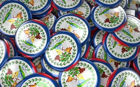 Belize Badges Background - Pile of Belizean Flag Buttons. Illustrazione stock