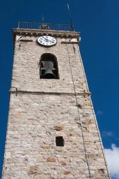Bell and clock tower with a dark blue sky background in Mougins Stock Photos