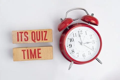 Bell and stick clock with the words Its Quiz Time. the concept of answering.. Stock Photos