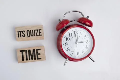 Bell and stick clock with the words Its Quiz Time. the concept of answering.. Stock Photos