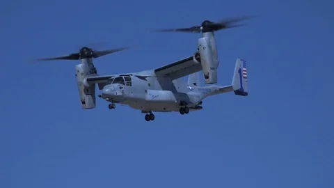 Bell Boeing V-22 Osprey rotates and begins to lands Stock Footage 87676498