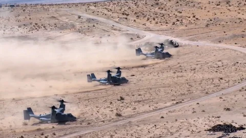 Bell Boeing V-22 Ospreys take off from desert Stock Footage 109575429