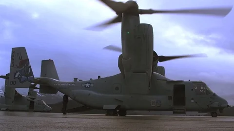 Bell Boeing V-22 Ospreys prepare to take off from a runway Stock Footage 114019302