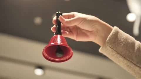 The bell in hand. Ring the red bell. Stock Footage 171463059