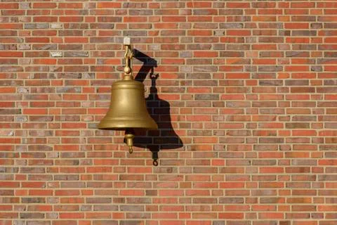 Bell hanging on a brick wall Stock-Fotos
