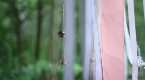 Bell hanging on a ribbon in the wind Stock Footage 67805937