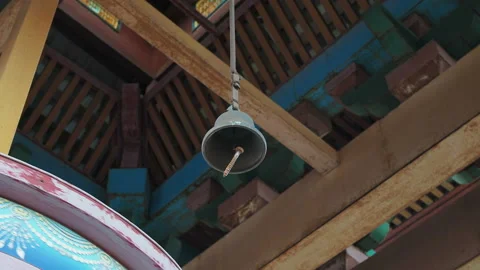 The bell hangs over the prayer wheel. Stock Footage 130347411