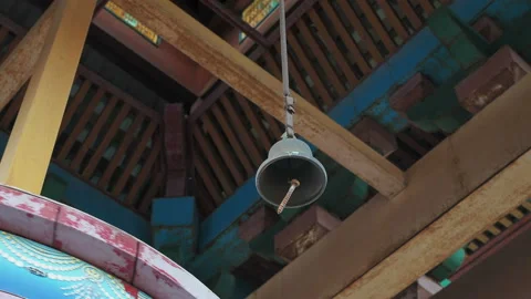 The bell hangs over the prayer wheel. Stock Footage 130347631
