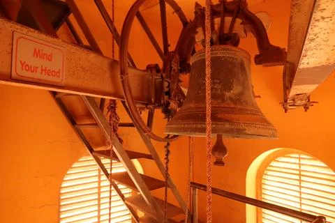 Bell inside the staircase of the bell tower of the St John the Baptist Chur.. Stock Photos