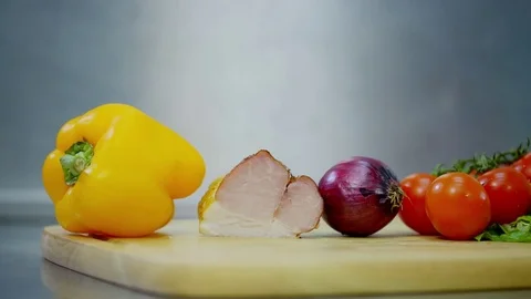 Bell pepper, bacon, onions, tomatoes and lettuce, lying on a wooden stand Stock-Footage 70969006
