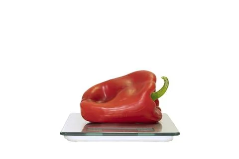 A bell pepper on a digital scale on a white background Stock Photos
