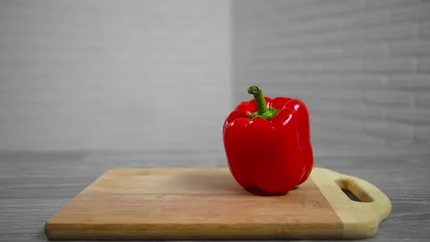 Bell pepper falls on a bamboo cutting board Stock Footage 195523868