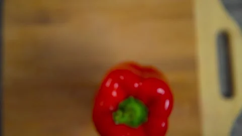 Bell pepper falls on a bamboo cutting board Stock Footage 195523871