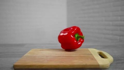 Bell pepper falls on a bamboo cutting board Video stock 195523872