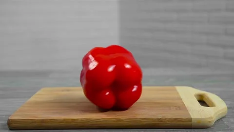 Bell pepper falls on a bamboo cutting board Stock Footage 195523902