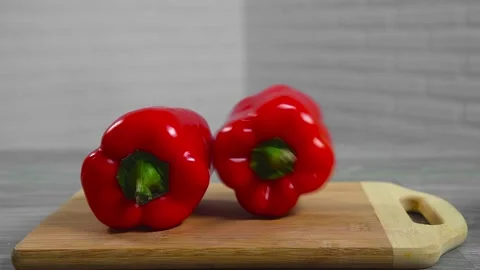Bell pepper falls on a bamboo cutting board Video stock 195523925