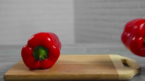 Bell pepper falls on a bamboo cutting board Stock Footage 195523926
